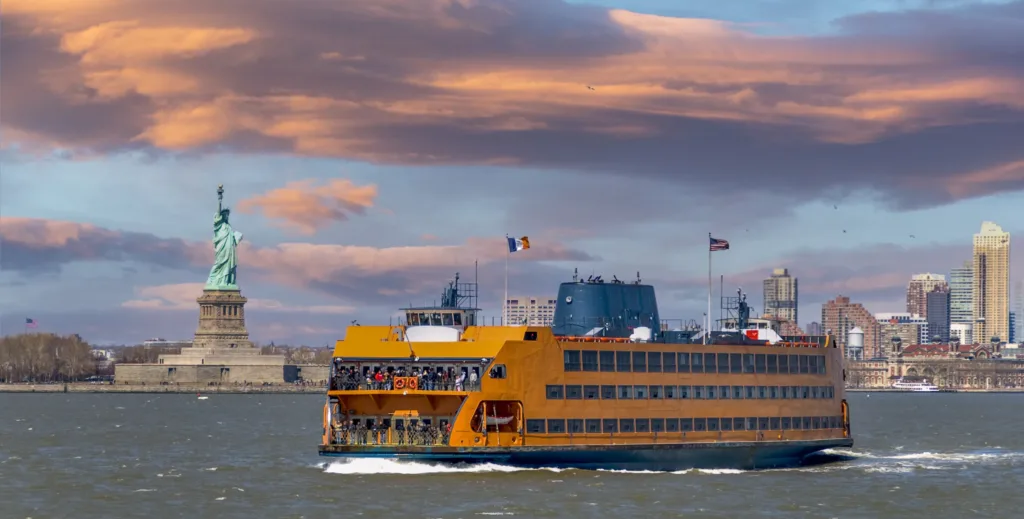 picture of ferry passing by the Statue of Liberty symbol of friendship of France and The United States