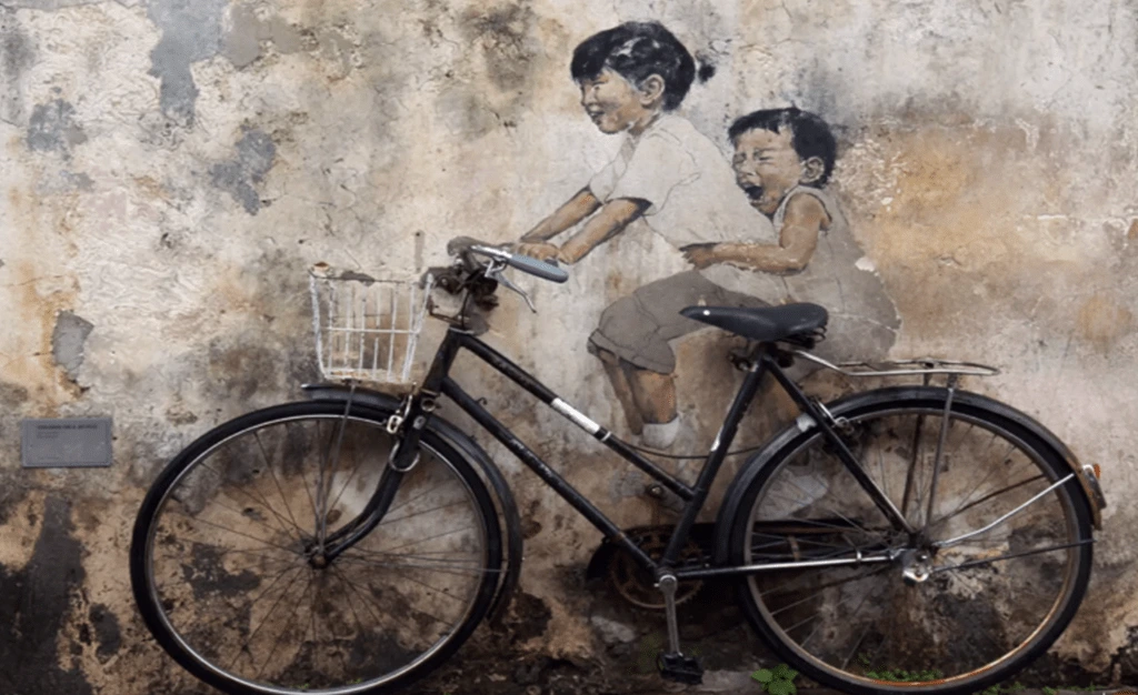 image of baby on bicycle street art Penang