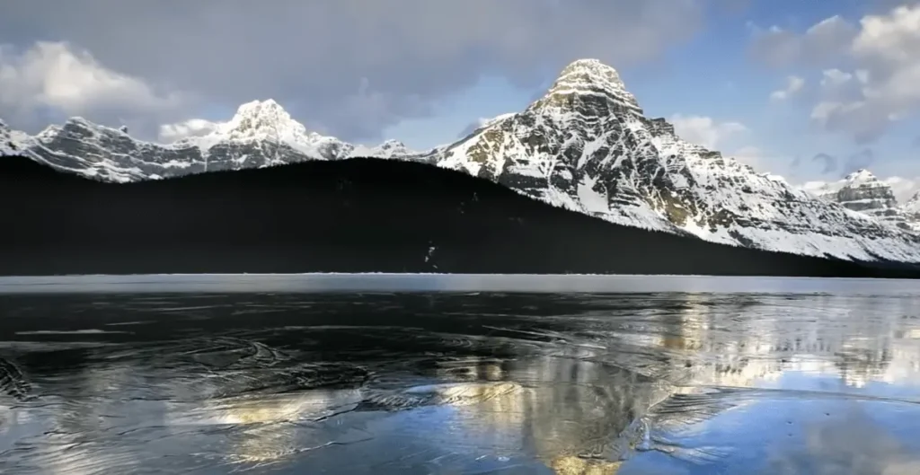 View of snow on Mountains & lake at Glacier National Park