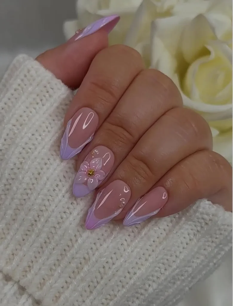 Hand holding press-on nail box showing reusable nails with 3D white flowers and application tools on marble background