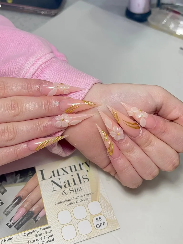  Medium coffin nails entirely in matte blush pink with 3D flowers, leaves, and base all matching in tone